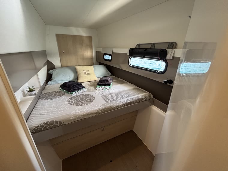 The forward cabin in the starboard hull, double bed and storage