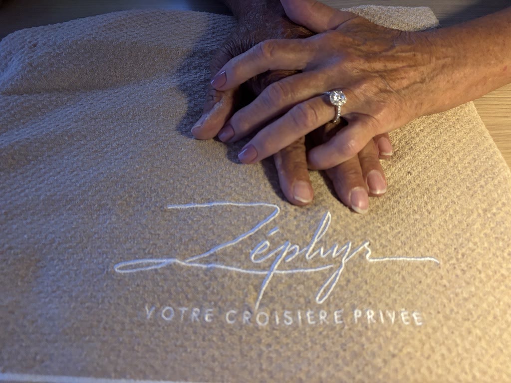 Two hands and an engagement ring, on board Zephyr