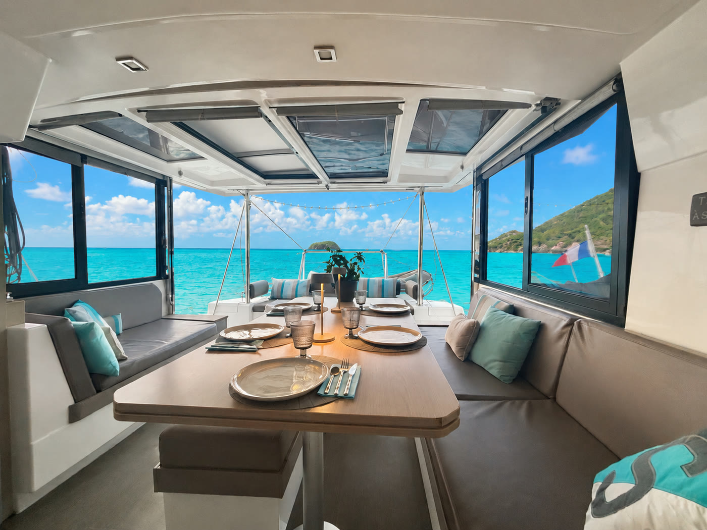 The saloon table set, looking out on the anchorage