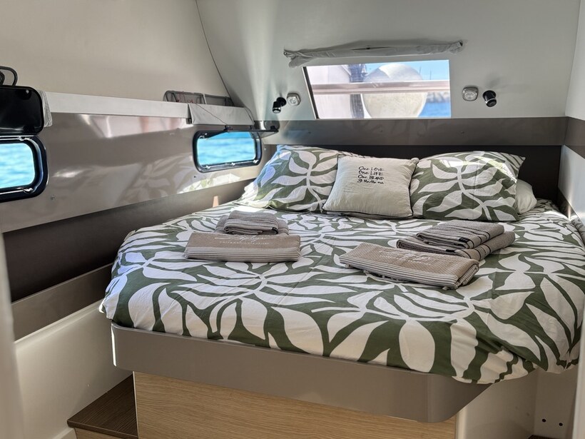 A double cabin aboard Zephyr, bed made for the night on board