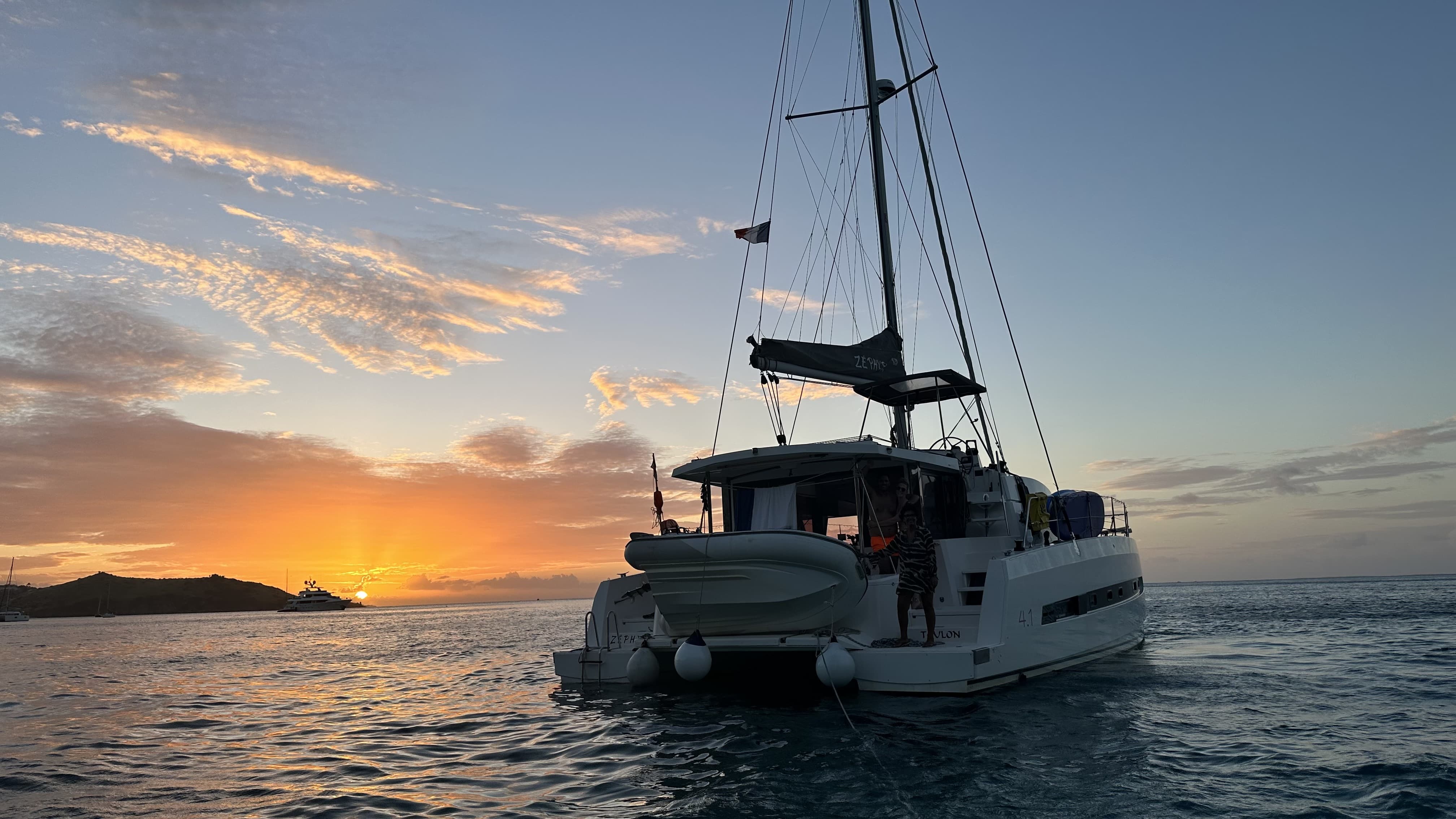 The catamaran Zephyr at sunset, lying at anchor